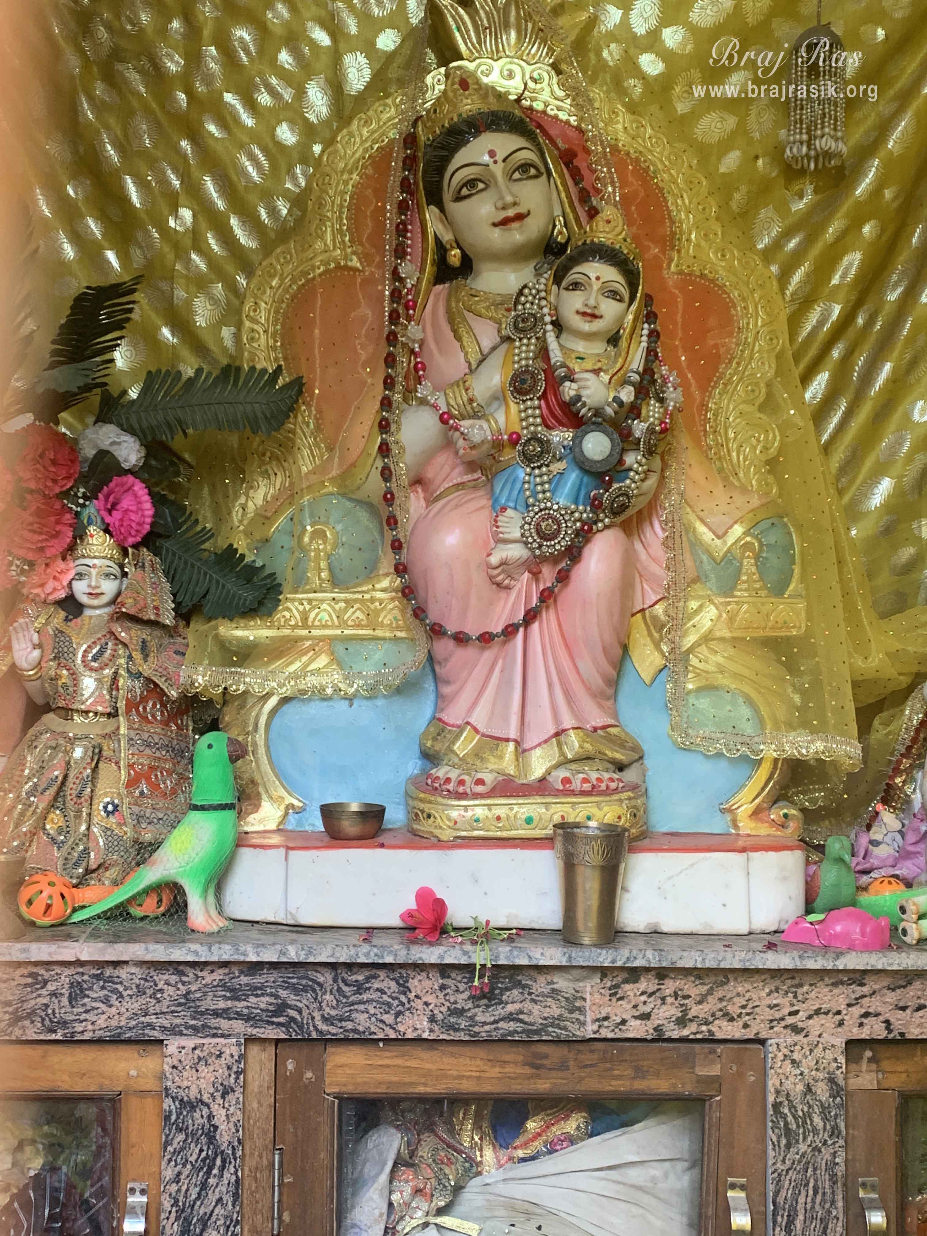 Darshan of Queen Kirti with Shri Radha on her lap in Kirti Tapah Sthali inside Khelan Van, Padar Van, Barsana.