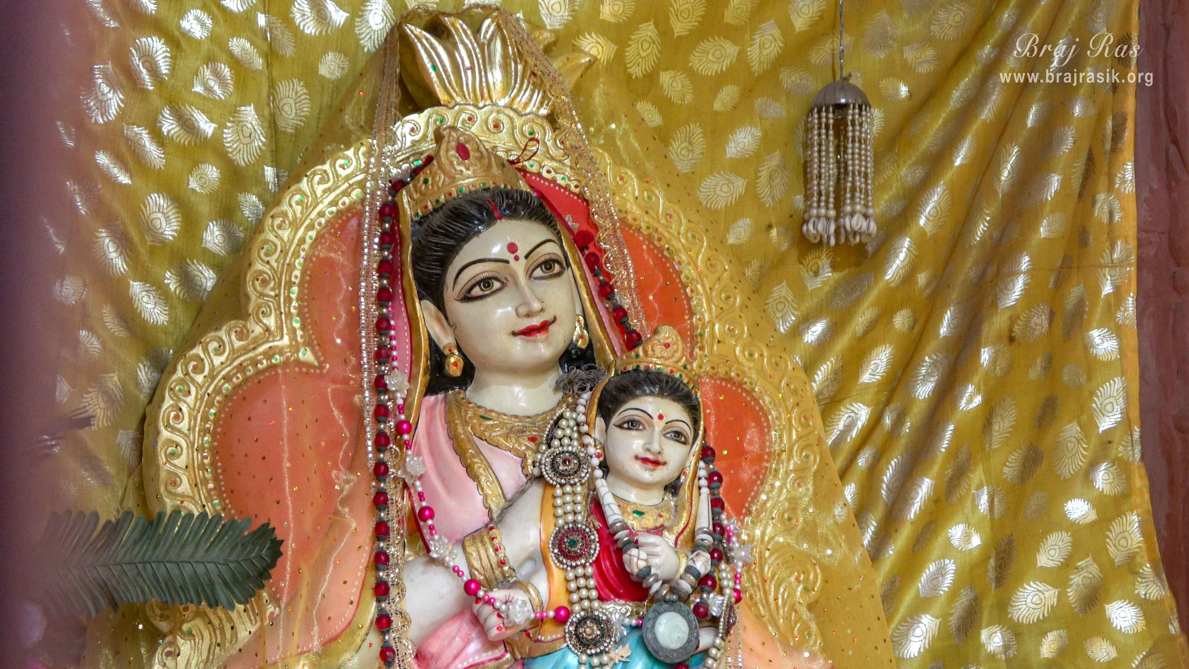 Close darshan of Queen Kirti with Shri Radha on her lap in Kirti Tapah Sthali inside Khelan Van, Padar Van, Barsana.