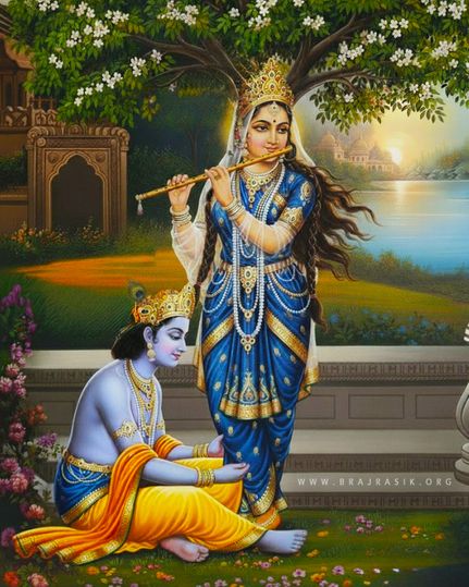 Supreme Queen Sri Radha is playing a flute at the bank of the Yamuna, and Sri Krishna is lovingly serving her lotus feet, sitting on the ground.